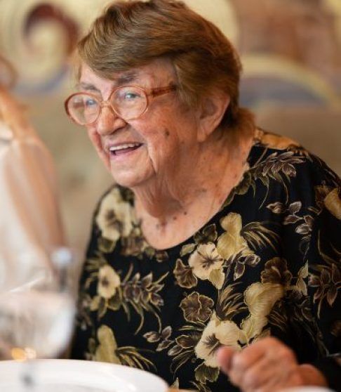Happy elderly woman at family dinner